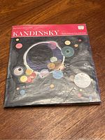Front cover of the Kandinsky art book showing an abstract painting of colorful circles on a black background with the title 'Kandinsky 48 Plates in Full Colour'.