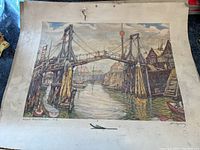 Print showing a wooden suspension bridge over water and coastal buildings with boats in the scene.