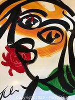 Close-up of face details showing bold black lines, orange and red brushwork and visible signature