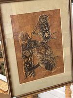 Full view of the framed artwork showing two owls on a tree branch with detailed textures and earth tone colors.