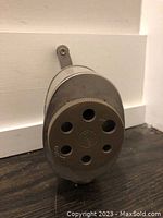 Front view of the metal pencil sharpener showing multiple hole sizes and USA/Boston marking