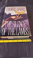 Front cover of the hardcover book 'The Silence of the Lambs' showing the title, author, and a Death's-head Hawkmoth.