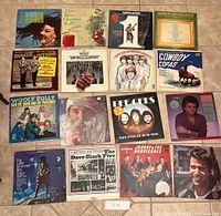 Top-down photo of 12 vintage record albums spread out into a 3x4 grid showing all album covers clearly.