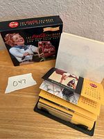 Photo of the boxed Coca-Cola 2001 calendar with original packaging and calendar pages partly visible.