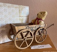 Wooden Coca-Cola crate style wagon holding the teddy bear with original seller's box in background.
