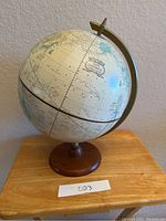 Full view of the vintage Crams Imperial globe on wooden base showing its classic design and coloration.