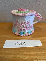Front view of the mug showing Happy Birthday text and floral trim