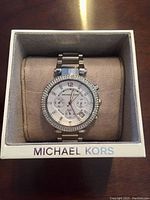 Watch displayed in Michael Kors box, front view