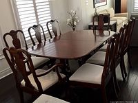 Front-angle view showing table with 8 chairs