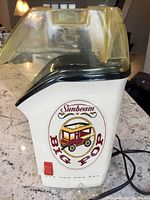 Side view showing the Sunbeam Big Pop logo, the power switch and power cord.