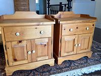 Two pine side tables side by side showing drawer and cabinet fronts