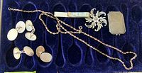 All jewelry pieces laid out in blue velvet tray