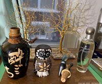 Image showing all items including 2 wire trees on tile bases, ceramic sake bottle, wood owl figurine, 3 bottle stoppers, and Estee Lauder Pleasures perfume bottle.