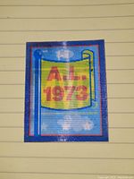 Front side of the small vintage baseball card showing 3D effect with 'A.L. 1973' on a yellow flag and blue background.