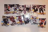 Twelve Fleer hockey cards spread out in two rows, showing players in various teams and action poses.
