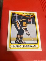 Front of Mario Lemieux hockey card showing player in Penguins uniform with team name and player name.