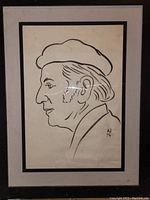 Framed black ink line drawing on paper showing a man's profile with a cap, signed 'W 76'. Framed under glass with black frame and white matting, measuring approximately 24x18 inches.