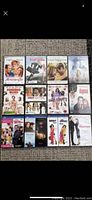 Photo of 15 DVDs laid out in a grid. Includes titles like The Perfect Score, Daddy Day Care, A Cinderella Story, Herbie Fully Loaded, and others.