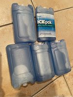 Five blue reusable ice packs, one with Cryopak ICE pak label.