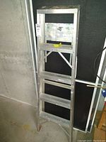 5-foot aluminum Werner stepladder with some paint stains and signs of wear