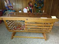 Full side view of the lobster trap style coffee table showing wooden slats, netting, and glass top.