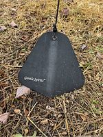 Close-up photo of the bottom wooden wind catcher labeled 'Gentle Spirits' showing weathered condition.
