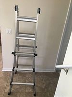 Multi-position ladder set in a folded step ladder position, showing front rungs and structure.
