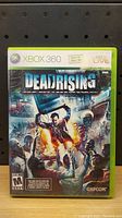 Front cover of Dead Rising Xbox 360 game showing artwork and branding details.