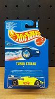 Photo of Hot Wheels Turbo Streak 1990 sealed in original blue Mattel packaging showing the car and card front.