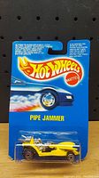 Front view of sealed Hot Wheels Pipe Jammer car in original blue packaging with blister pack and Hot Wheels logo.