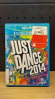 Front view of Just Dance 2014 game case for Nintendo Wii U showing colorful cover art and title.