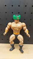 Front view of one muscular Masters of the Universe action figure with green helmet and fur boots.