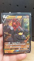 Front of Coalossal V Pokémon trading card showing character, HP, attacks, and artwork.