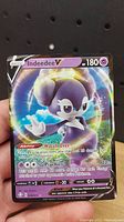 Front of Indeedeed V Pokémon card showing name, HP, type, ability, attack, and art.