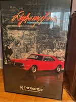 Framed Pioneer Firebird poster showing red muscle car and graffiti background