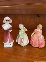 Front view of three Royal Doulton figurines Sophie (left), Rose (middle), Barbie (right)