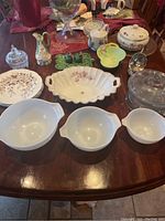 Photo of all serving pieces together on table including Pyrex bowls, crystal, ceramic and porcelain items