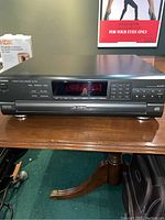 Front view of Technics SL-PD6 CD changer unit showing digital display, control buttons, and disc drawer.