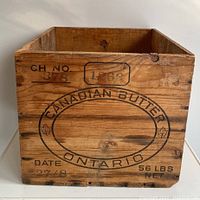 Front view of antique wooden Canadian butter crate showing Canadian Butter Ontario text and markings