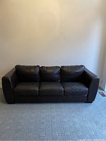 Front view of dark brown leather three-seat sofa