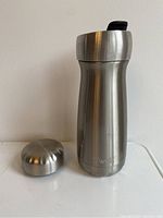 S'well stainless steel reusable coffee mug with the full closure lid removed, showing the open bottle.