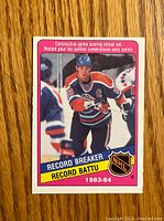 Front of the 1984-85 O-Pee-Chee Wayne Gretzky hockey card showing Wayne Gretzky in Edmonton Oilers uniform, highlighting his record-breaking streak in the 1983-84 NHL season.