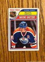 Front of 1984-1985 O-Pee-Chee Wayne Gretzky hockey card showing player's image, jersey, year, team, and name.