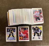 Full display of a large stack of hockey cards and four featured cards including Jagr, Fedorov, Roenick, and Domi rookies.