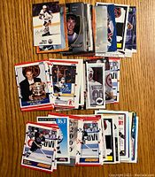 Front sides of assorted Wayne Gretzky hockey cards showing various action shots and portraits, laid out on a wooden surface.