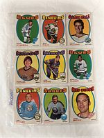 Front view of nine O-Pee-Chee 1971-72 hockey cards showing player portraits and team logos with colorful backgrounds.
