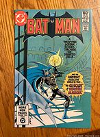 Front cover of Batman comic book issue #341 showing Batman holding a candle on stairs.
