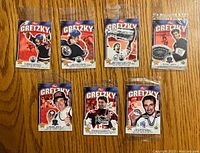 Front view of seven sealed Post Cereal Wayne Gretzky hockey cards with various images including Stanley Cup and team action