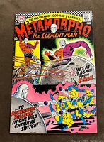 Front cover of Metamorpho The Element Man #11 comic book with colorful hero action scene and title branding.