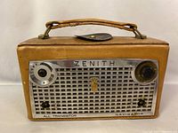 Front view of radio showing brand, model, and control knobs.